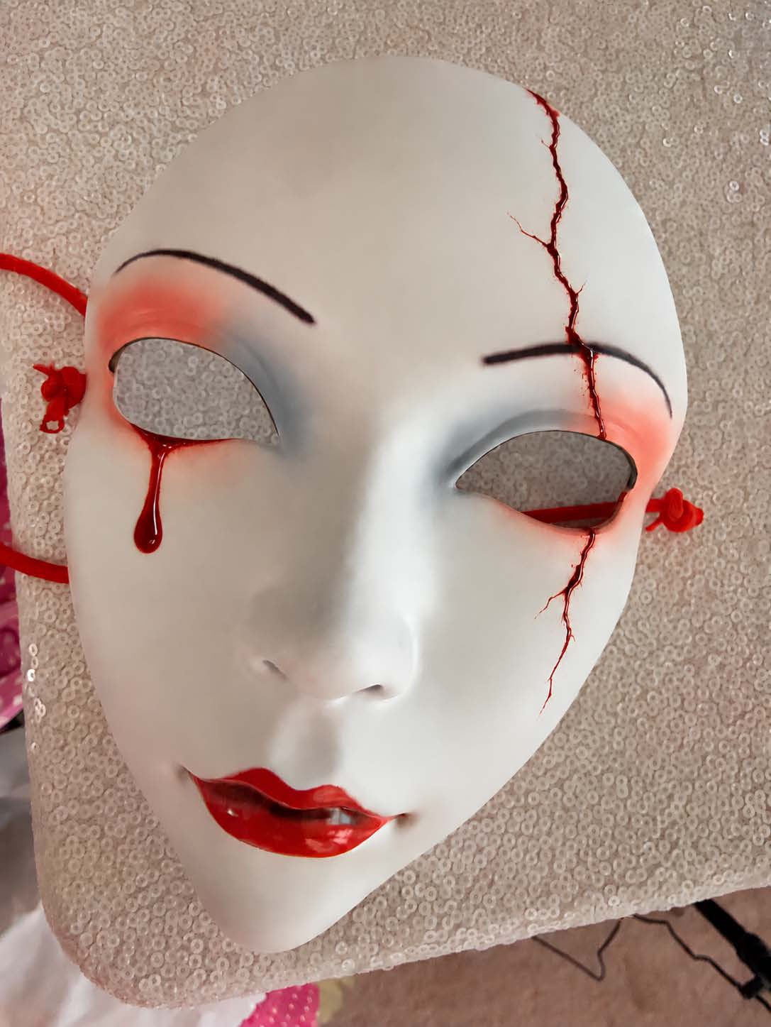 The cracked china doll mask worn by the Pie Killer